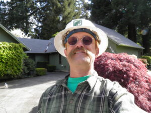 David. D. Hunter, certified arborist, working in a neighborhood