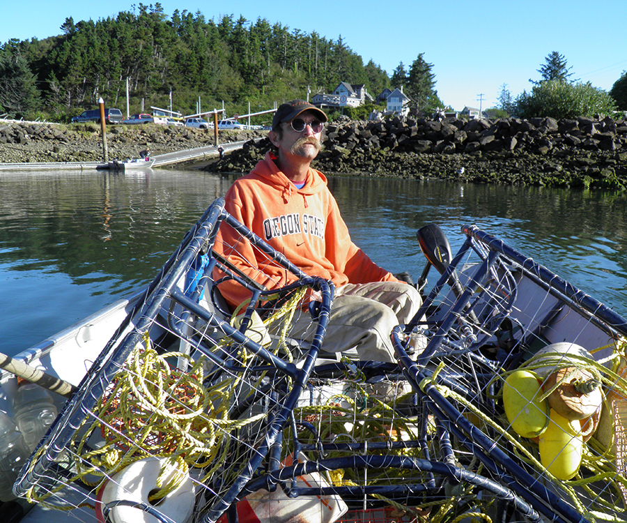 David D. Hunter, certified arborist, sitting in boat with fishing gear