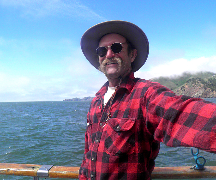 David D. Hunter, certified arborist, with backdrop of ocean on a boat