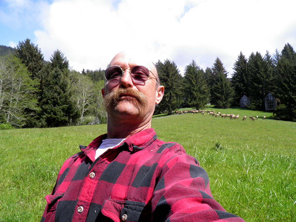 david d. hunter, certified arborist in front of field with